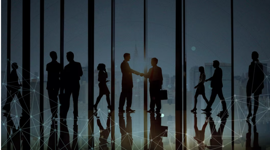 A silhouette of businessmen networking with each other to showcase how to network at a conference