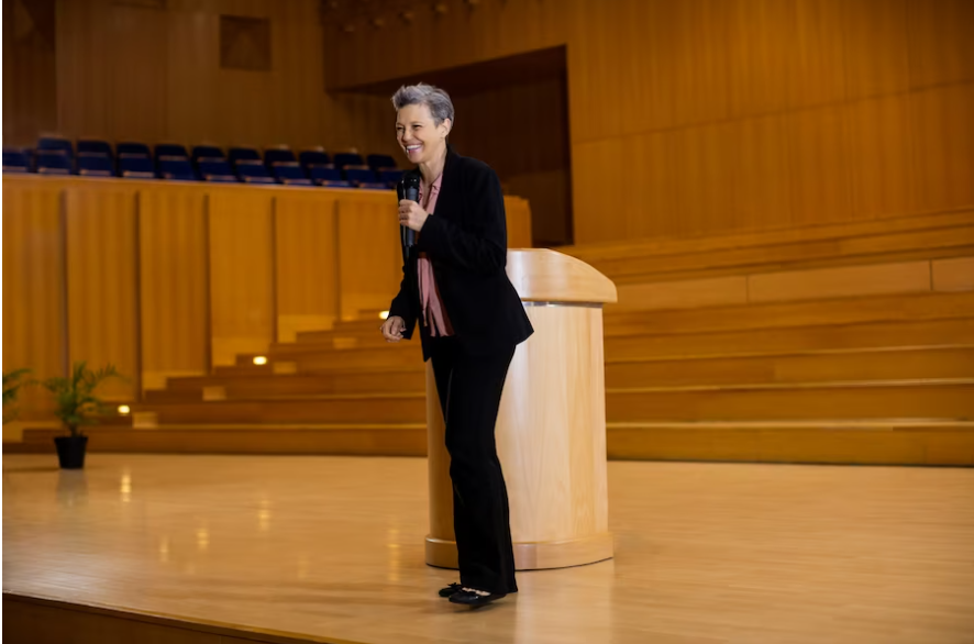 A smart Caucasian woman wearing a black formal attire, showcasing what to wear to a conference