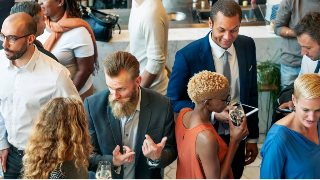 A group of professionals informally discussing networking event ideas over wine during a networking event